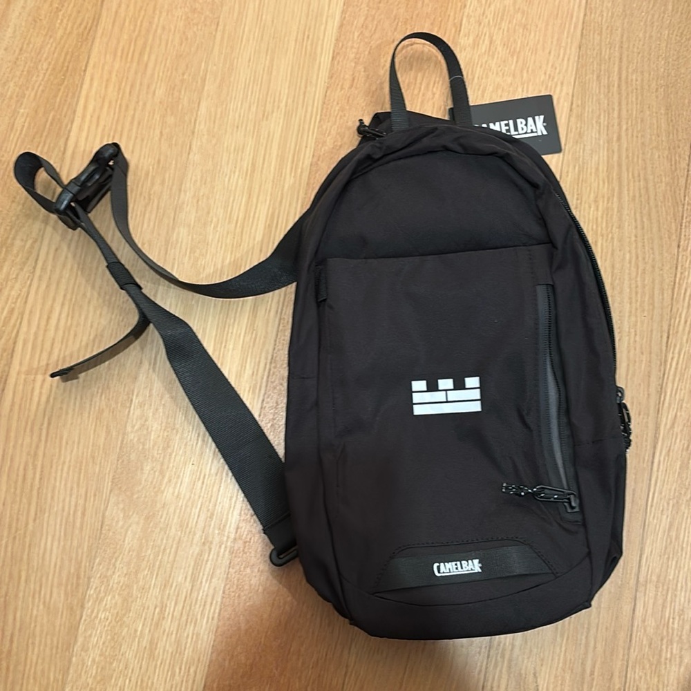 Camelback cross body carrier, new with tags.  Insulated water bottle pocket.